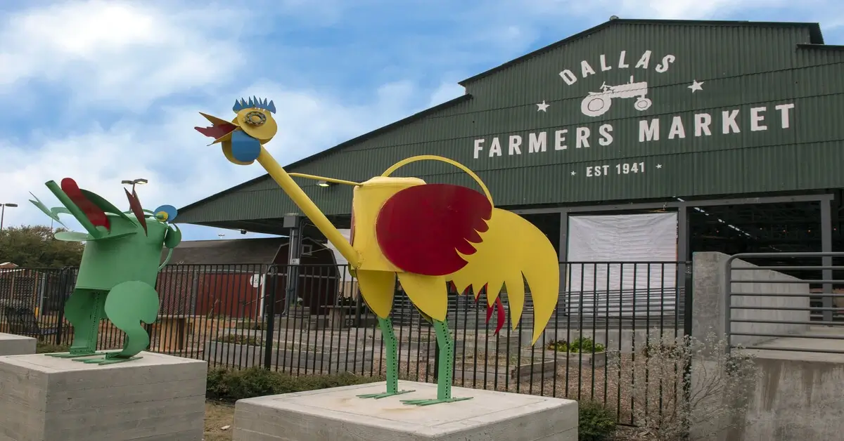 Metal sculptures of frog and rooster in front of the dallas farmers market.
