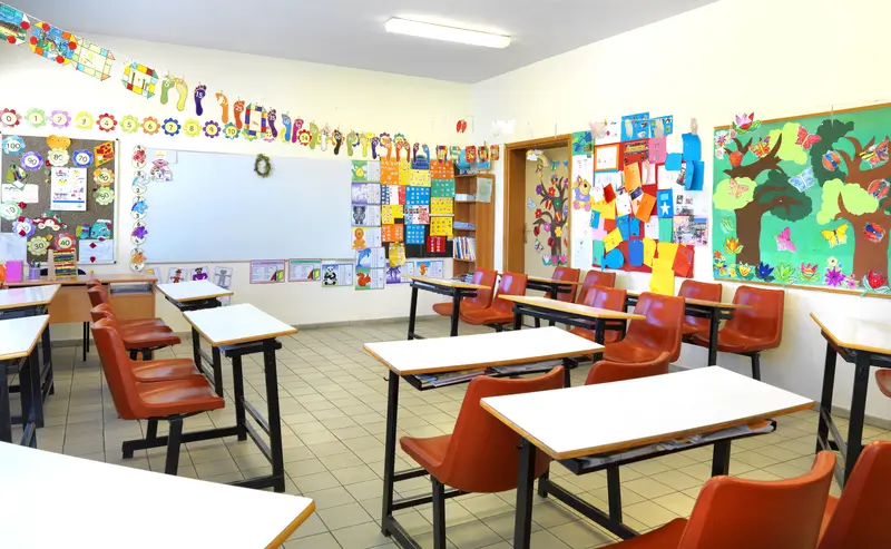 Empty classroom while kids are in the school garden.